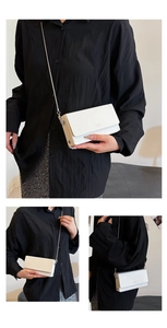 Detailed macro view of ivory matte leather square bag with metal chain strap