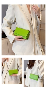 Detail of neon green leather shoulder bag with sleek metal chain and magnetic flap