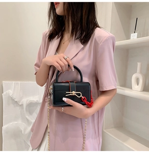 Chic black glossy mini box bag with golden butterfly lock and red acrylic chunky chain