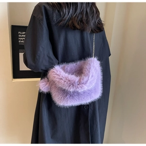 Chic purple plush shoulder bag detail showing soft fluffy texture, chain strap and cute pom-pom.
