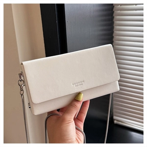 Close-up of white minimalist square bag featuring silver chain and 1998 logo engraving