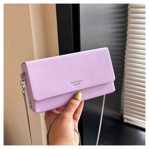 Detail of lavender rectangular flap bag with silver chain strap and brand logo