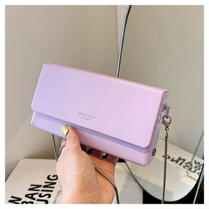 Detail of light purple rectangular chain bag featuring textured finish and silver strap