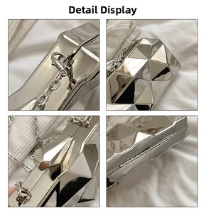 Detailed close-up of silver geometric evening clutch bag with metal chain and clasp