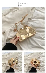Macro shot of gold geometric evening bag with faceted mirror texture and chain strap