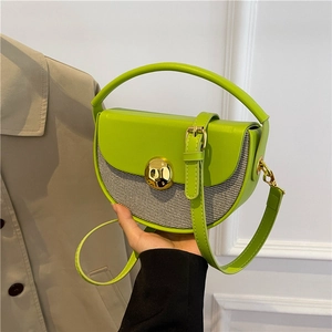 Green leather semicircular handbag with woven texture and gold buckle detail