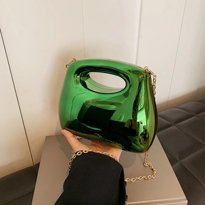Green acrylic handbag with futuristic geometric shape and golden metal chain strap