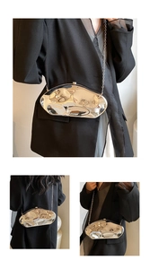Detail of silver liquid metal style acrylic bag with mirror finish and chain strap