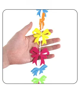 Close-up of vibrant multi-colored felt butterfly bunting held in hand for party decoration