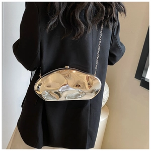 Close-up of a gold geometric mirror-finish acrylic clutch bag with a metal chain strap