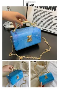 Blue marble acrylic evening bag with gold metal handle and chain strap detail