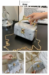 Gray marble acrylic clutch bag with golden animal handle and thin metal chain strap