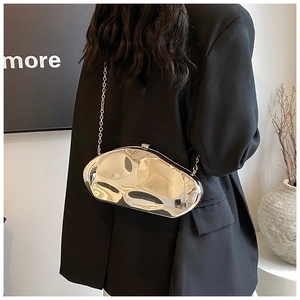 Modern metallic irregular cloud clutch bag with mirror silver finish and chain strap on model