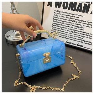 Blue marble acrylic box clutch with a gold leopard handle and thin chain strap detail