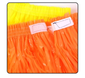 Detail of Halloween hula skirt with velcro closure and plastic fringe in yellow and orange