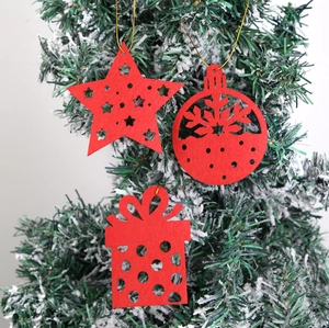 Detailed view of red felt Christmas tree ornaments with star, ball and gift box designs