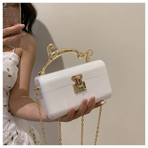 Chic pearl white acrylic clutch bag featuring a gold leopard handle and chain strap