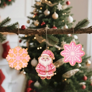 Detailed close-up of pink and orange wooden snowflake ornaments with a cute Santa hanging