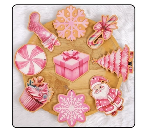 Close-up of pink Christmas wooden pendants on round tray with snowflake and sock shapes