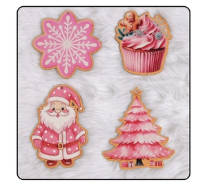 Detailed view of four pink and white wooden Christmas tree ornaments on faux fur