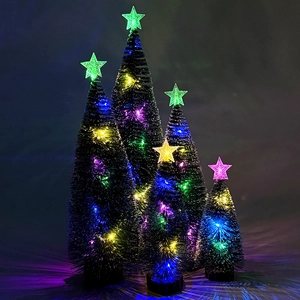 Close-up of set of 4 mini lighted snowy Christmas trees with colorful LED stars