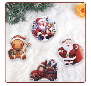 Detailed view of four festive wooden Christmas tree ornaments on a white plush background