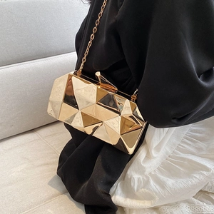 Golden geometric cube clutch bag with 3D faceted shell and elegant metallic chain strap