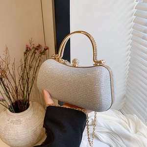 Silver glitter evening box clutch with gold ring handle and sparkling rhinestone clasp