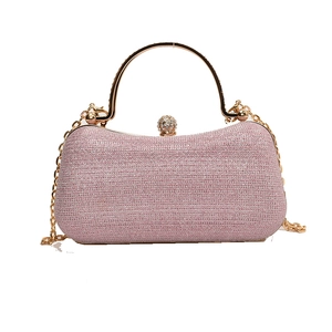 Pink glitter evening clutch bag with gold round handle and elegant metal chain strap