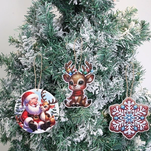 3D printed wooden Christmas ornaments with Santa and reindeer hanging on a tree