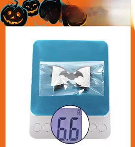 Close-up of Halloween bat hair bow in packaging weighing 6.6g for pets and parties