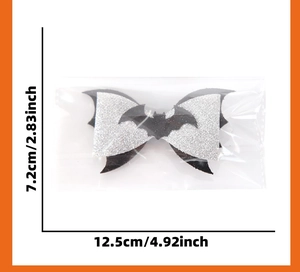 Detail view of a silver glitter Halloween bow with a black bat motif and size measurements