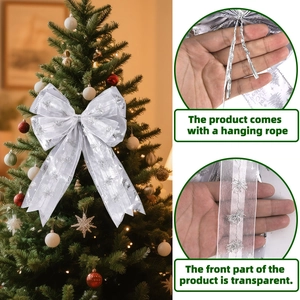 Detailed view of silver sheer Christmas bow with snowflake patterns and Merry Christmas text