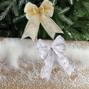 Detail of Christmas tree bows with gold sequins and silver Merry Christmas ribbons