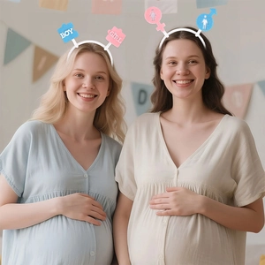 Close-up of Gender Reveal headbands with Boy and Girl signs worn by smiling models