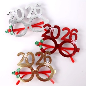 Close-up of glittery 2026 New Year decorative glasses in gold, silver and red color