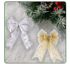 Detail of silver and gold mesh Christmas bows with snowflake prints and Merry Christmas text