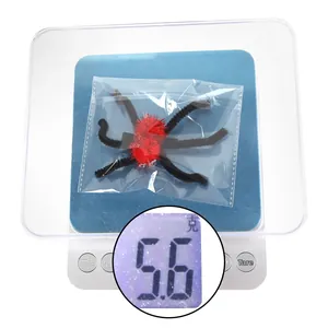 Detail view of the lightweight spider hair clip on a scale weighing 5.6 grams
