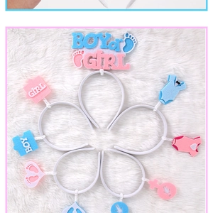 Detail of gender reveal felt headbands with Boy and Girl text on plush background