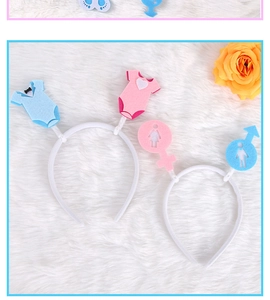 Detail view of Gender Reveal party headbands with baby suit and gender icons