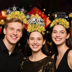 Three people wearing black and gold 2026 Happy New Year headbands with tinsel fringe