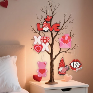 Detail view of Valentine's Day wooden gnome and heart ornaments hanging on a rustic branch