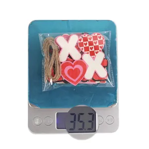 Detailed view of Valentine's Day wood heart ornaments with twine and checkerboard patterns