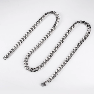 Macro detail of silver stainless steel curb link chain with secure lobster clasp