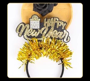 Close-up of black and gold Happy New Year headband with tinsel and gift box details
