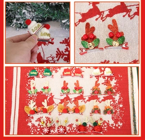 Detail of Christmas pet hair clips featuring reindeer antlers and holiday themed decorations
