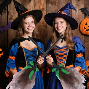 Detail of Halloween witch broom featuring mesh bristles and a green ribbon bow decoration