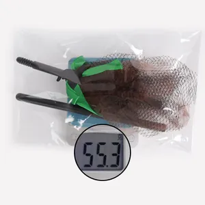 Close-up of Halloween witch broom prop showing 55.3g weight on an electronic scale
