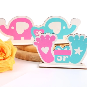 Gender reveal party wood decor with pink and blue baby feet and elephant design