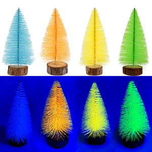 Detail of four mini fluorescent Christmas trees with natural wood bases in vibrant colors